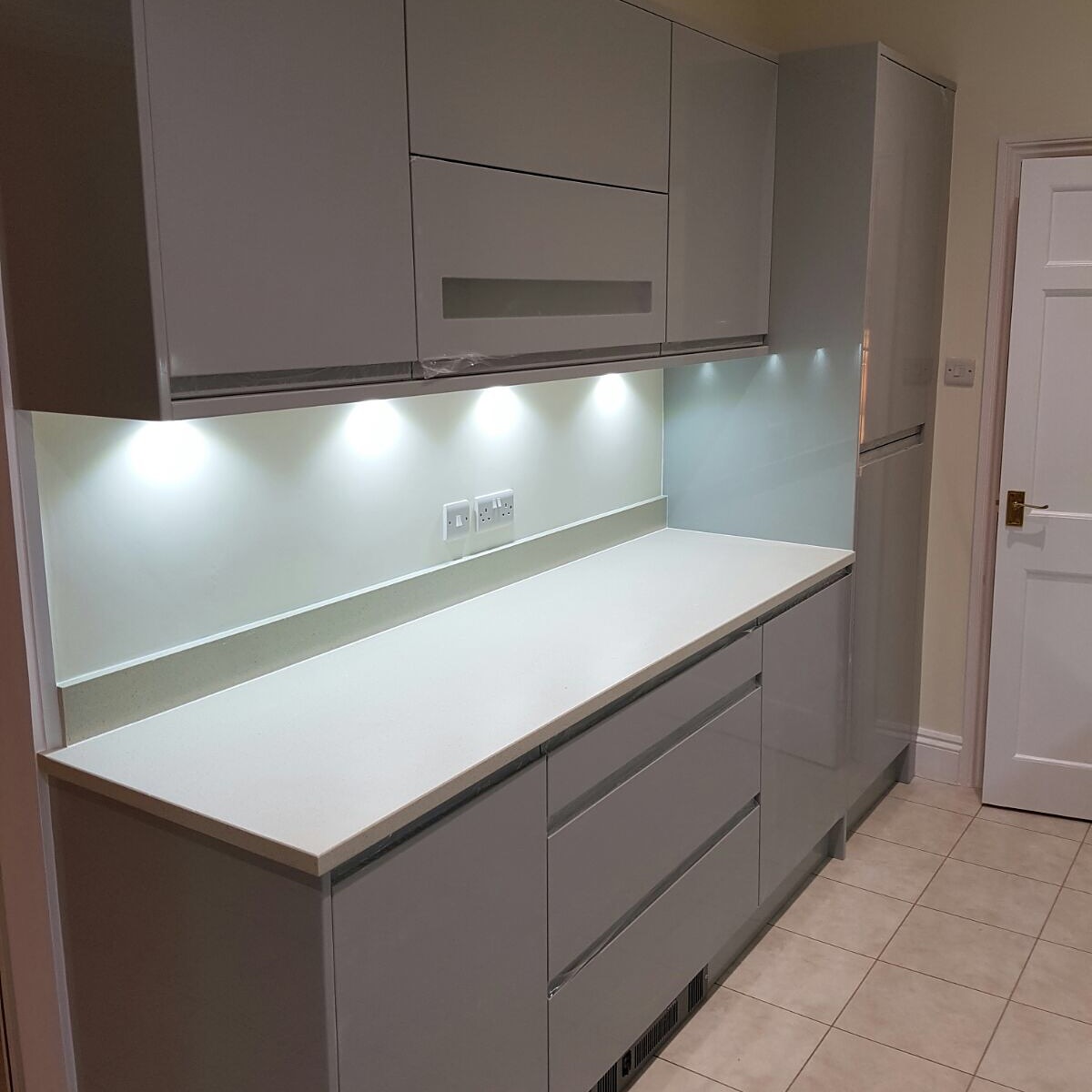 Close view of completed modern kitchen cabinetry and worktops