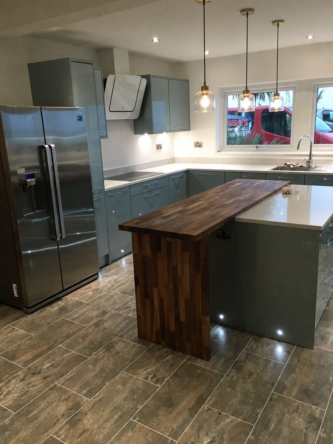 Completed kitchen island with three pendant lights