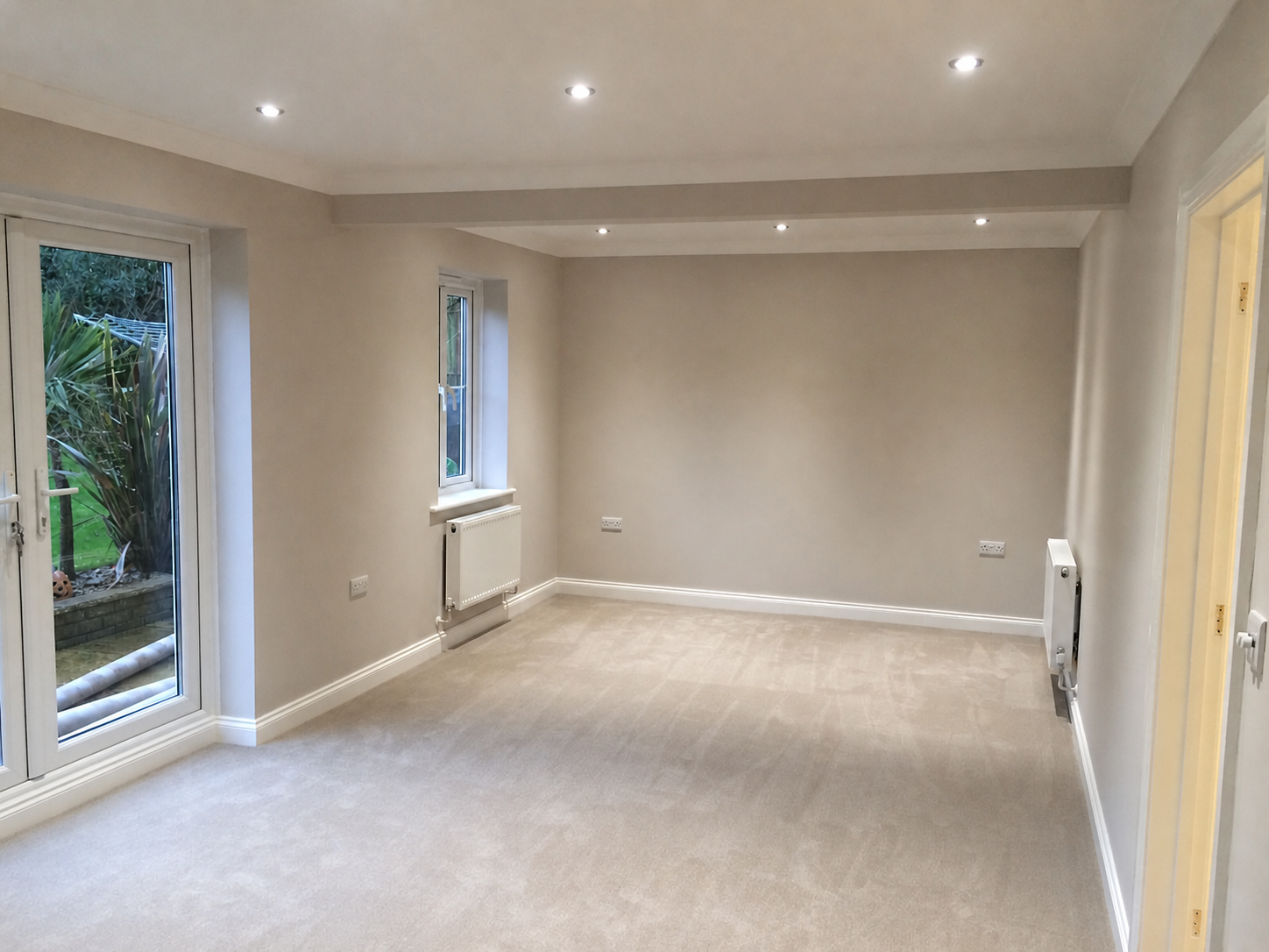 Completed carpeted room with decorating, lighting and interior finishing
